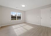 Thumbnail 20 of 76 - an empty living room with a white door and a window