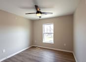 Thumbnail 11 of 58 - A room with a ceiling fan and a window.