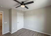 Thumbnail 10 of 58 - A room with a ceiling fan and a door.
