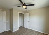 Thumbnail 9 of 58 - A room with a ceiling fan and two doors.