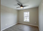 Thumbnail 8 of 58 - A room with a ceiling fan and a window.