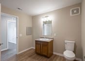 Thumbnail 4 of 58 - A bathroom with a toilet, sink, and mirror.