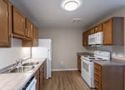 Thumbnail 2 of 58 - A kitchen with white appliances and wooden cabinets.