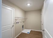 Thumbnail 13 of 58 - A small, empty room with a door on the left and a closet with a hanging rod.