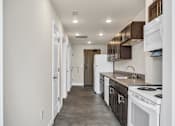 Thumbnail 40 of 51 - a kitchen with white appliances and a concrete floor