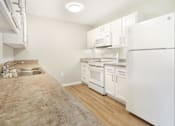 Thumbnail 19 of 26 - a kitchen with white appliances and white cabinets