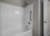 Thumbnail 20 of 22 - a white bathroom with a shower and a tub