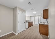 Thumbnail 40 of 51 - a renovated kitchen and living room with white walls and wood floors