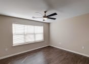 Thumbnail 10 of 26 - a bedroom with a large window and a ceiling fan