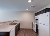 Thumbnail 8 of 26 - a kitchen with white appliances and wood flooring