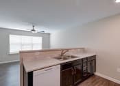 Thumbnail 4 of 26 - a kitchen with a sink and a ceiling fan