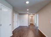 Thumbnail 20 of 26 - a bedroom with hardwood floors and beige walls