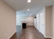 Thumbnail 23 of 26 - a kitchen and living room with hardwood floors and beige walls
