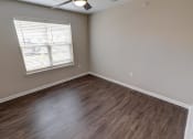 Thumbnail 18 of 26 - an empty room with a window and a ceiling fan