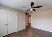 Thumbnail 24 of 26 - a bedroom with a ceiling fan and closet