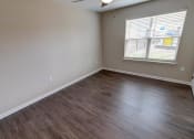 Thumbnail 14 of 26 - an empty room with a window and a ceiling fan