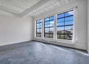 Thumbnail 38 of 51 - an empty room with large windows and a concrete floor