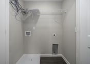 Thumbnail 22 of 22 - a walk in closet in a bathroom with a tub and a rack on the wall