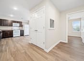 Thumbnail 15 of 35 - a renovated kitchen with white cabinets and a wood floor