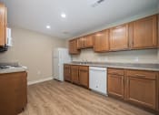 Thumbnail 15 of 48 - A kitchen with wooden cabinets and a white fridge.