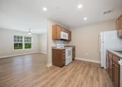 Thumbnail 2 of 48 - A kitchen with wooden cabinets and a white refrigerator.