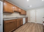 Thumbnail 10 of 48 - A kitchen with wooden cabinets and a white fridge.