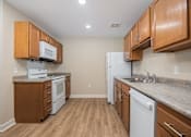 Thumbnail 7 of 48 - A kitchen with wooden cabinets and a white refrigerator.