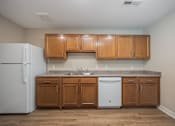 Thumbnail 17 of 48 - A kitchen with wooden cabinets and a white fridge.