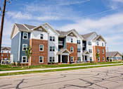 Thumbnail 1 of 48 - A row of houses with a blue sky in the background.