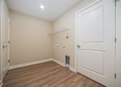Thumbnail 39 of 48 - A room with a white door and a small white shelf above it.