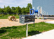 Thumbnail 31 of 48 - A playground with a slide and a swing set.