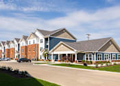 Thumbnail 32 of 48 - A row of houses with a clear blue sky above them.