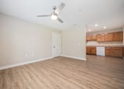 Thumbnail 20 of 48 - A room with a ceiling fan and wooden flooring.