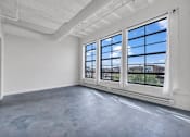 Thumbnail 30 of 51 - an empty room with large windows and a concrete floor
