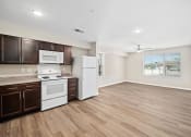 Thumbnail 13 of 35 - a kitchen with white appliances and wooden floors
