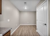 Thumbnail 43 of 51 - the kitchen and living room of a new home with white walls and wood flooring