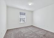 Thumbnail 39 of 49 - A room with a carpeted floor and a window with blinds.
