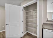 Thumbnail 37 of 51 - a closet with shelves and a white door
