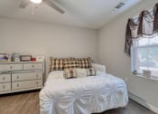 Thumbnail 38 of 50 - a bedroom with a bed and a dresser