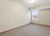 Thumbnail 38 of 66 - A room with a window and a carpeted floor.