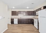 Thumbnail 27 of 35 - a kitchen with white appliances and dark wood cabinets