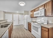 Thumbnail 39 of 51 - a kitchen with white appliances and wooden cabinets