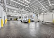 Thumbnail 31 of 51 - a parking garage with several cars in it