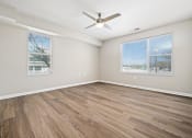 Thumbnail 19 of 35 - an empty living room with a ceiling fan and a window