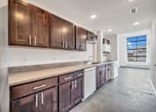 Thumbnail 43 of 51 - a kitchen with wooden cabinets and a white dishwasher