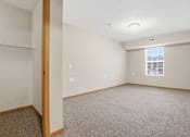 Thumbnail 42 of 66 - Empty room with carpeted floor and white walls.