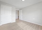 Thumbnail 1 of 78 - an empty living room with white walls and wood floors