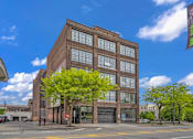 Thumbnail 7 of 51 - a large brick building with a tree in front of it