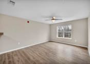 Thumbnail 1 of 51 - an empty living room with a ceiling fan and a window