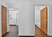 Thumbnail 46 of 49 - A hallway with two doors on either side.